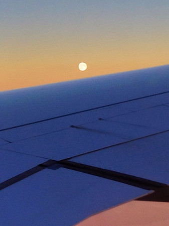 The Super Moon rises over the plane's wing
